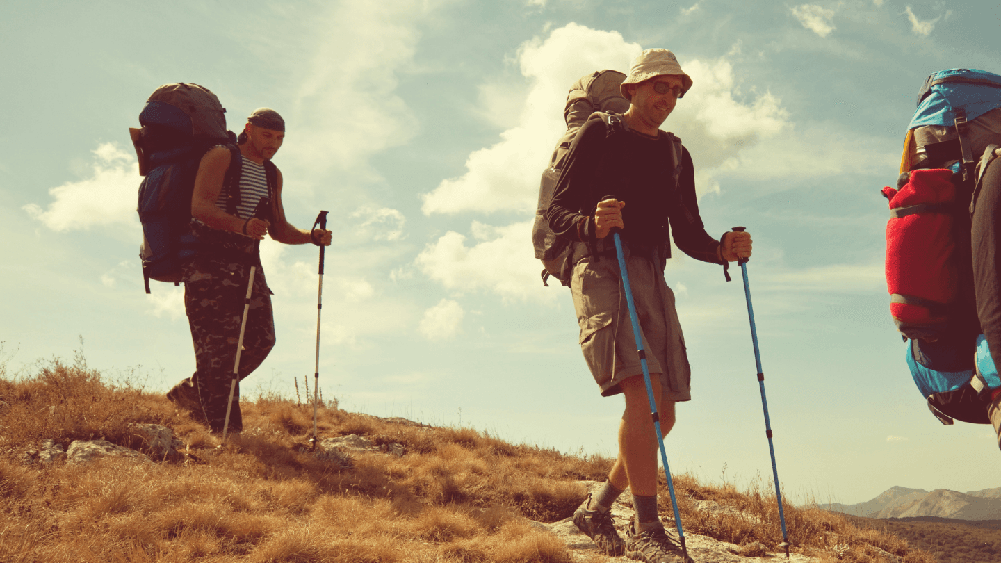 Person checking a smartwatch in a warm mountain setting