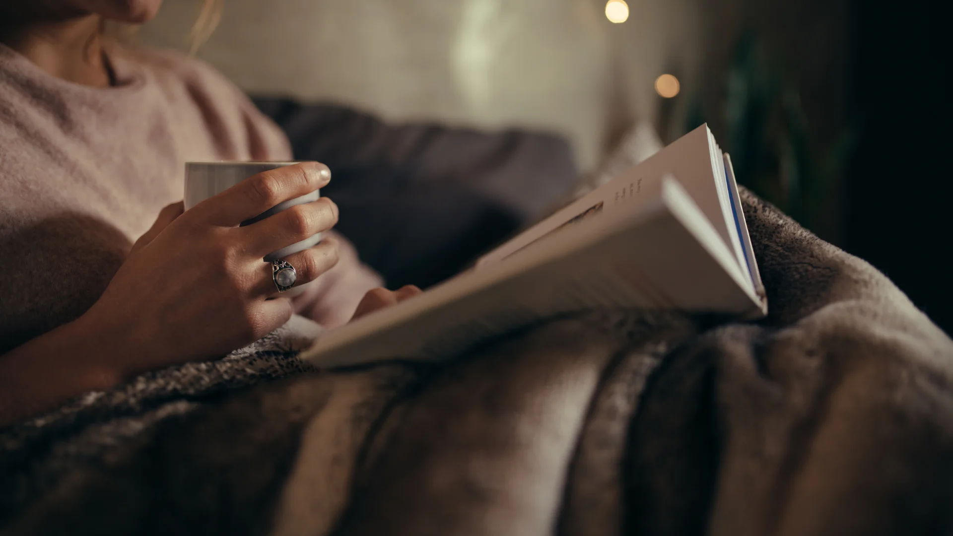 Person winding down with a warm drink and a book